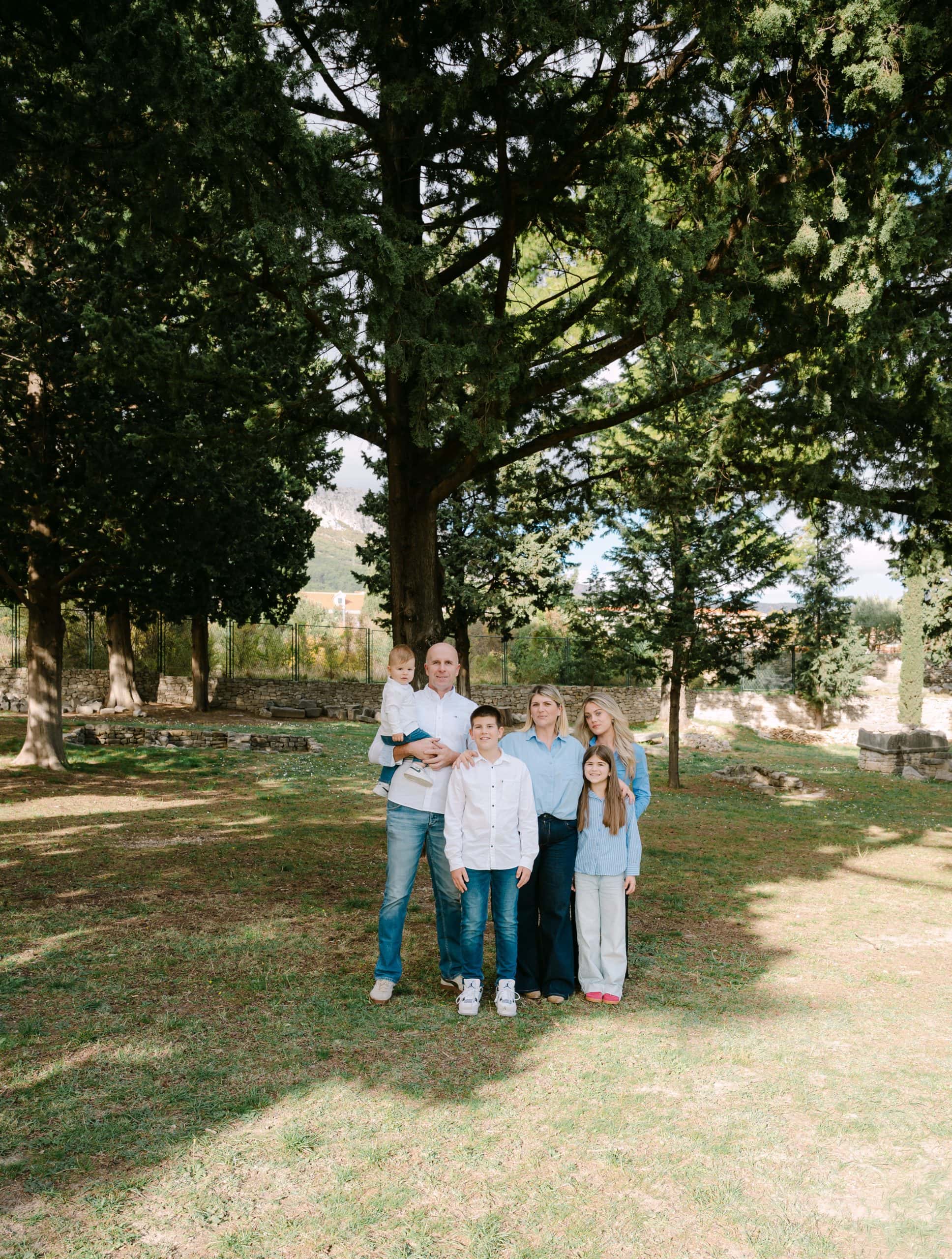 Obiteljski portret na otvorenom ispod velikog drveta.