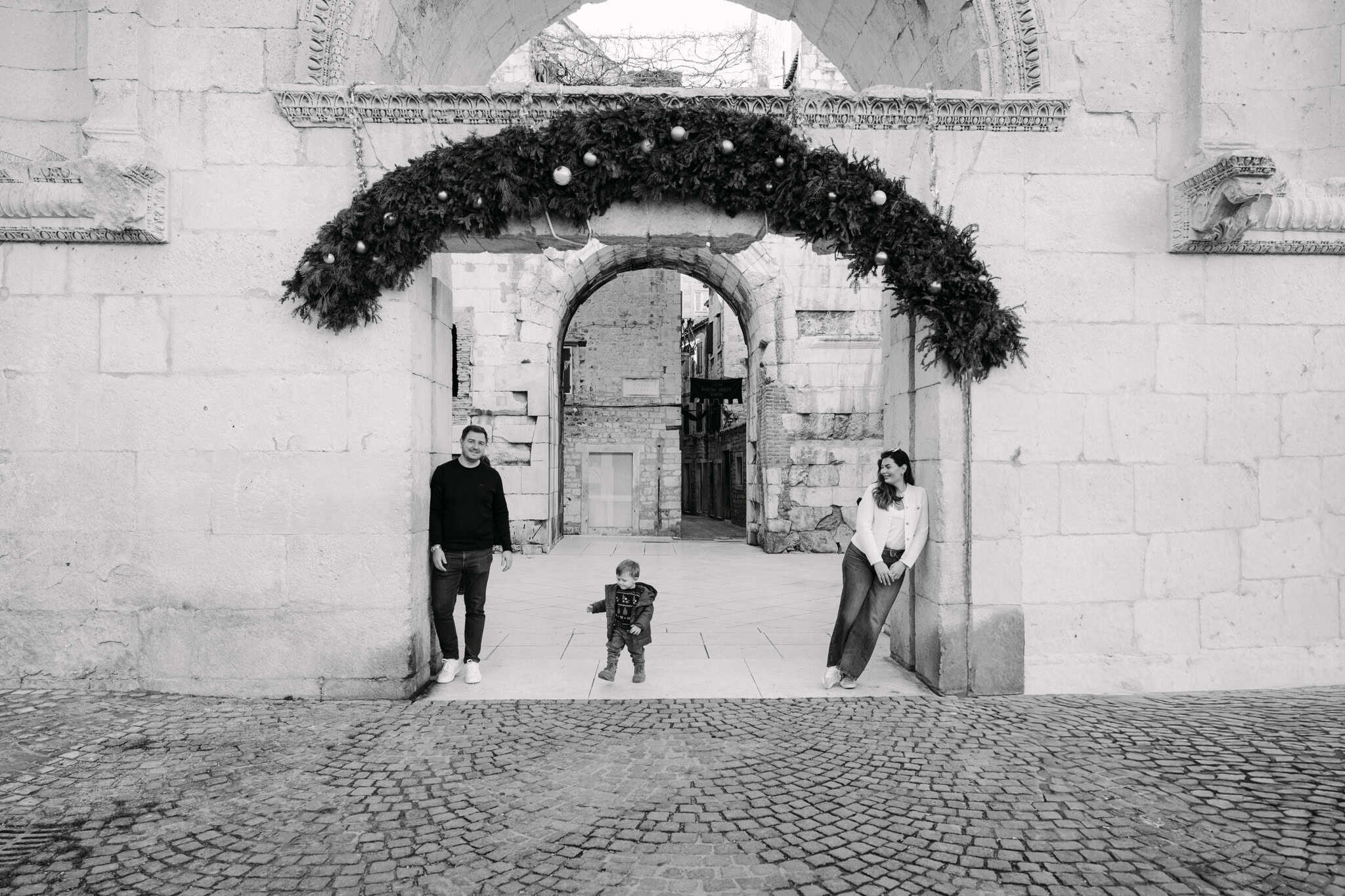 Povijesna gradska vrata s obitelji koja uživa u fotografiranju na otvorenom u Splitu u Hrvatskoj.
